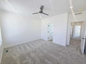 Carpeted empty room with ceiling fan