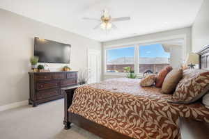 Bedroom with light carpet and ceiling fan