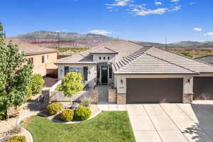 View of front of home featuring a mountain view and a garage