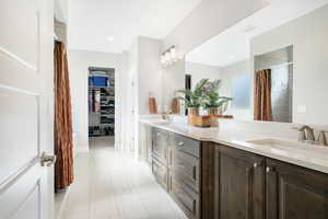 Bathroom with tile patterned floors and dual bowl vanity