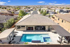 View of swimming pool with an in ground hot tub, a patio, and an outdoor bar