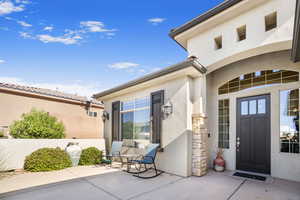 Doorway to property with a patio area