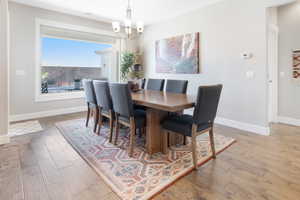 Dining space featuring hardwood / wood-style flooring and an inviting chandelier