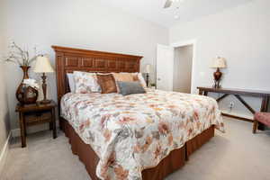 Carpeted bedroom featuring ceiling fan