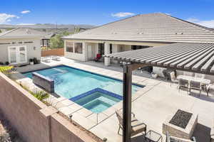 View of pool with a mountain view, a patio, an in ground hot tub, and french doors