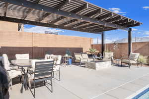 View of patio / terrace with a pergola and an outdoor fire pit