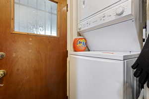 Washroom with stacked washer and clothes dryer