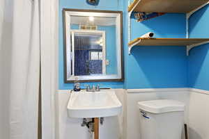 Bathroom featuring sink and toilet