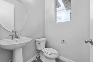 Bathroom featuring hardwood / wood-style floors, toilet, and sink