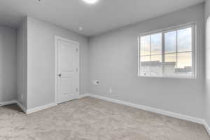 Empty room with light colored carpet