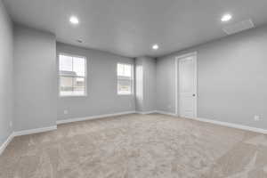 Carpeted empty room with a textured ceiling