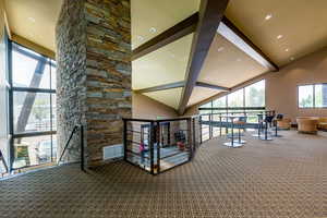 Interior space with high vaulted ceiling and carpet