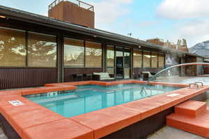 View of pool featuring a jacuzzi and a mountain view