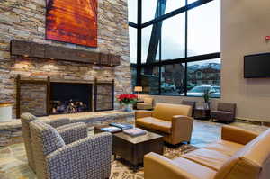 Living room with a fireplace and a towering ceiling