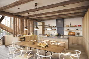 Dining space with beam ceiling and light hardwood / wood-style floors