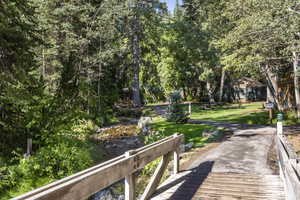 View of home's community featuring a yard and a water view