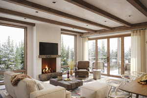 Living room with french doors, a fireplace, and beam ceiling