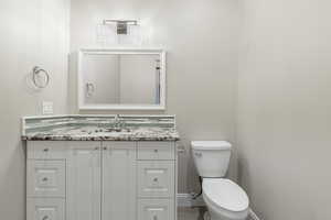 Bathroom featuring vanity and toilet