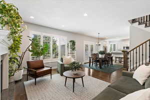 Living room featuring hardwood / wood-style flooring and a notable chandelier