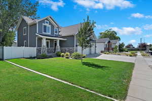 View of front of house with a garage and a front yard