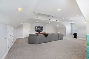 Carpeted living room with vaulted ceiling and a textured ceiling