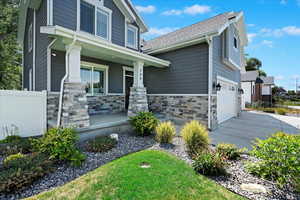 View of front of property featuring a porch and a garage