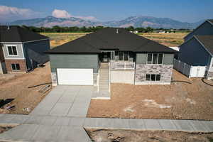 View of front of house featuring a mountain view and a garage