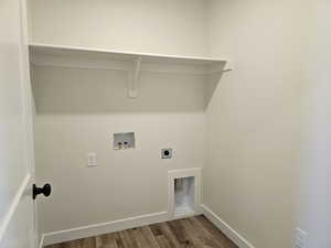 Clothes washing area with hookup for a washing machine, dark wood-type flooring, and electric dryer hookup