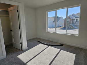 Unfurnished bedroom featuring a closet and carpet floors