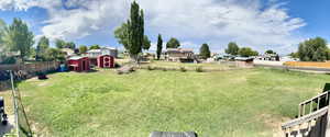 View of yard with a storage shed