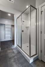 Bathroom with walk in shower, tile patterned flooring, and a textured ceiling