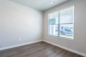 Unfurnished room featuring dark hardwood / wood-style flooring