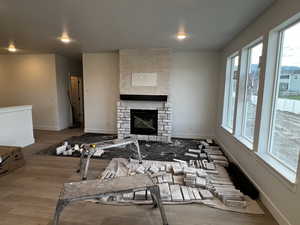 Living room with a fireplace and wood-type flooring