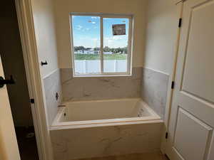 Bathroom with a relaxing tiled tub