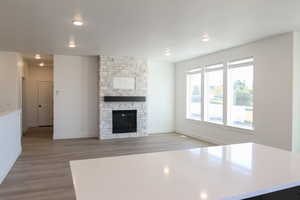 Unfurnished living room featuring a fireplace and light wood-type flooring