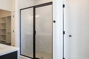 Bathroom featuring vanity and a shower with shower door