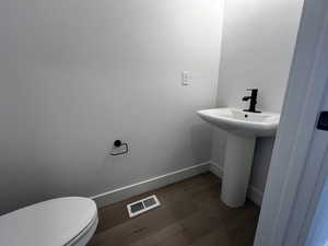 Bathroom with wood-type flooring and toilet