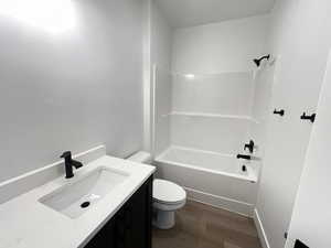 Full bathroom featuring shower / bathing tub combination, vanity, toilet, and hardwood / wood-style flooring