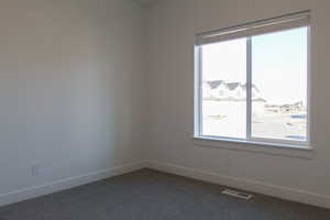 Carpeted empty room featuring plenty of natural light