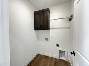 Laundry room with cabinets, hardwood / wood-style flooring, hookup for an electric dryer, and hookup for a washing machine