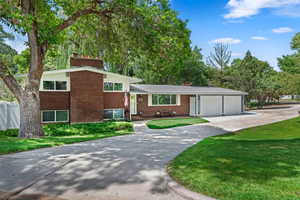 Tri-level home with a garage and a front lawn