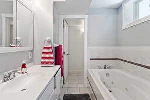 Bathroom featuring tile patterned floors, vanity, and a textured ceiling