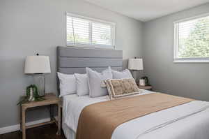 Bedroom with dark wood-type flooring