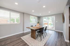 Dining room featuring dark wood-type flooring