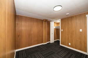 Unfurnished room with wood walls