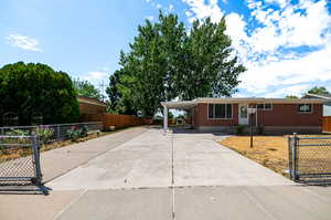 Single story home featuring a carport