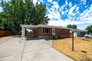 View of front of property with a carport