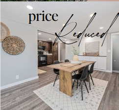 Dining room with light hardwood / wood-style flooring and a chandelier