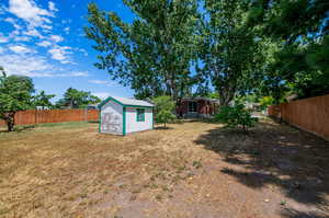 View of yard featuring a storage unit