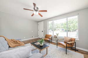 Living room featuring ceiling fan and wood-type flooring